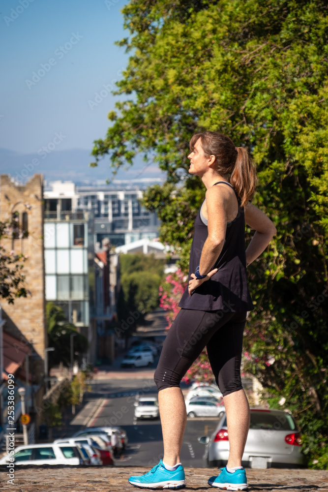 female fitness athlete sstanding in an urban setting
