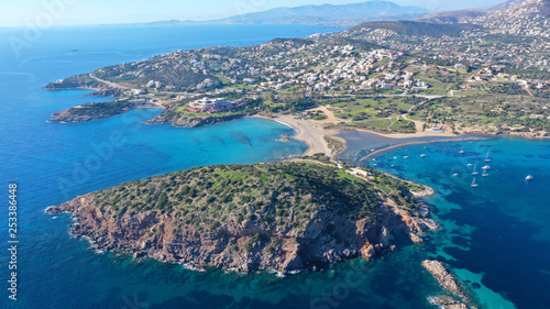 Aerial drone photo of famous small islet with picturesque chapel of Agios Nikolaos and small marina, Anavissos area, Attica, Greece © aerial-drone