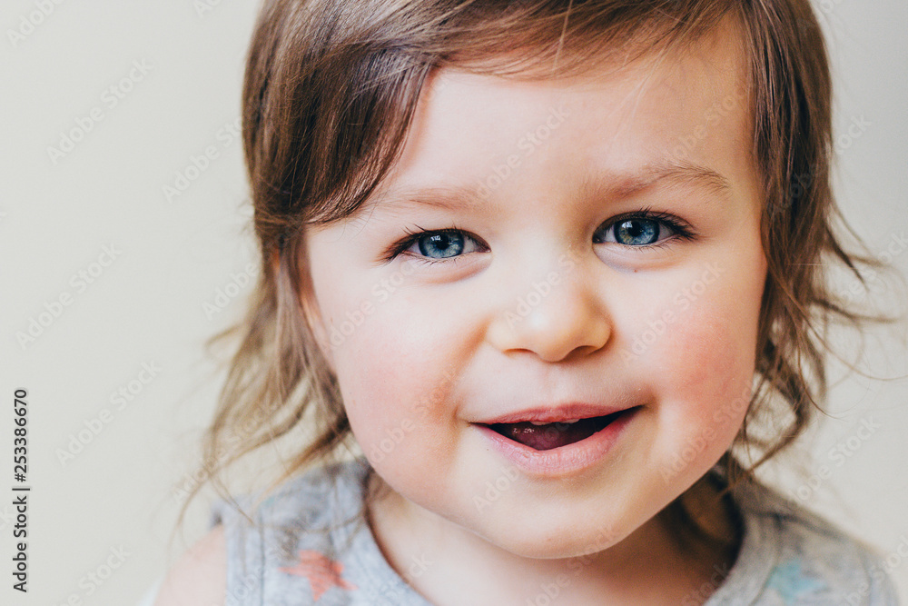 Happy Smiling Baby Toddler Girl Looking Positive and Funny, Neutral Background Happy Smiling Baby Toddler Girl Looking Positive and Funny, Neutral Background