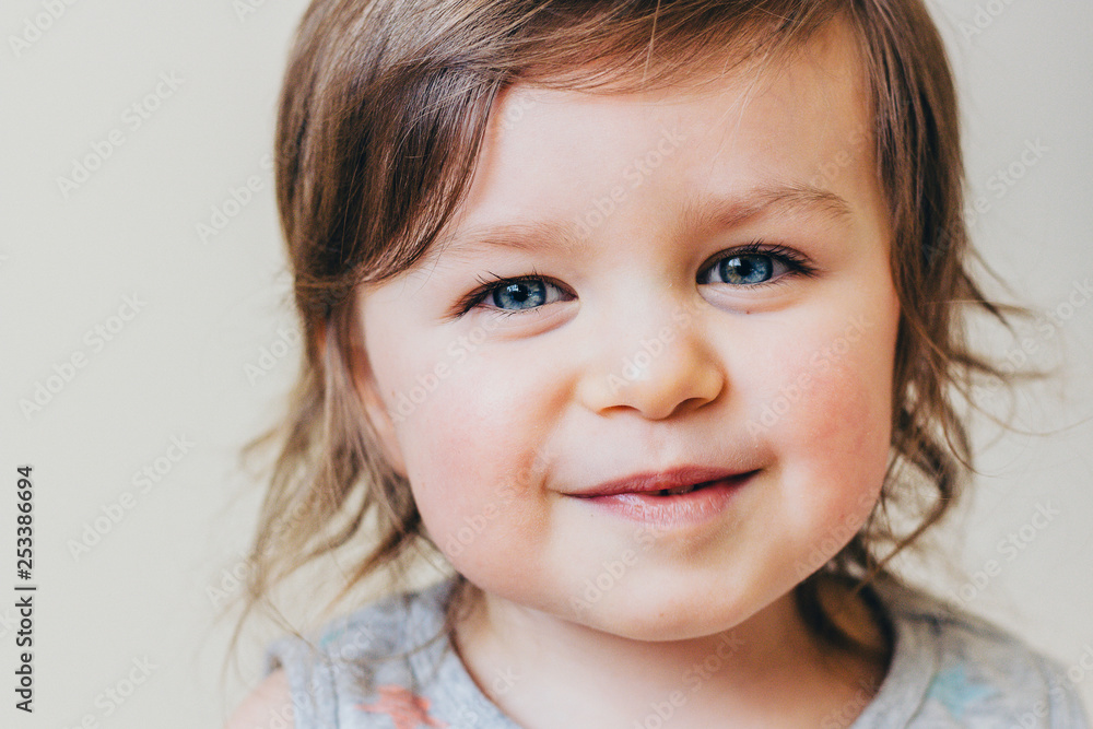 Smiling Happy Beautiful Baby Girl Closeup With Blue Eyes, Neutral Background Smiling Happy Beautiful Baby Girl Closeup With Blue Eyes, Neutral Background