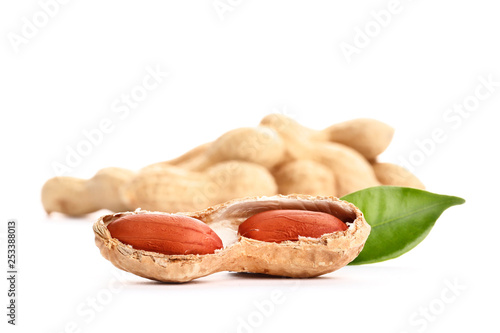 Raw peanuts on white background with green leaf. Healthy snack ona white background.Top view. close-up.