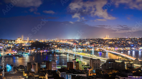 Panoramic view of Bosphorus with lots of illuminated bridges and mosques. Istanbul cityscape at night with cloudy sky. Touristic famous place of Turkey © tramster