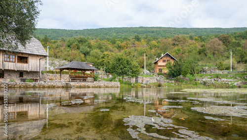 old wooden mill and bridge at gacka river spring in central croatia