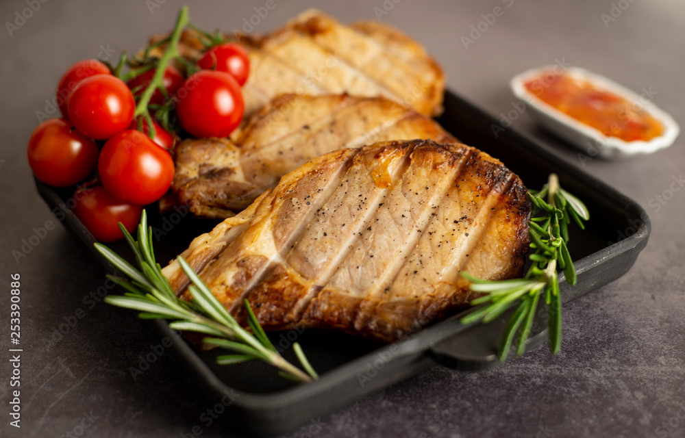 Steaks from pork and cherry tomatoes Steaks from pork and cherry tomatoes
