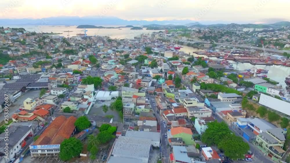 Drone flying forwards and sideways at Rio de Janeiro, over the city, with buildings, mountains, favela, cars passing by - summer season beautiful landscape. Drone flying forwards and sideways at Rio de Janeiro, over the city, with buildings, mountains, favela, cars passing by - summer season beautiful landscape.