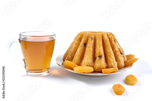 Rum Baba with a cup of tea on a white background