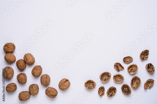 walnut kernels and shells on white background