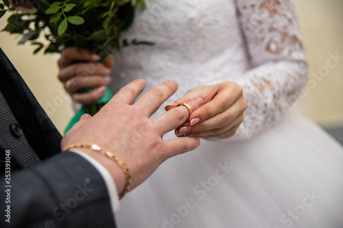 the bride wears a ring to the groom
