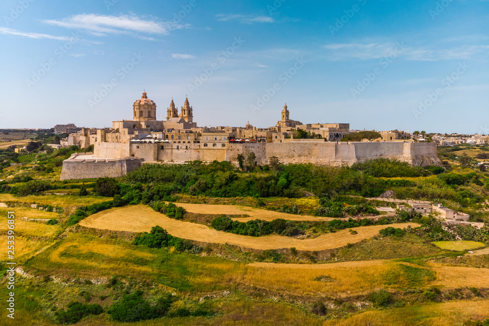 Aerial view Of Mdina City. Old Capital Of Malta Country. Blue sky and green yellow fields