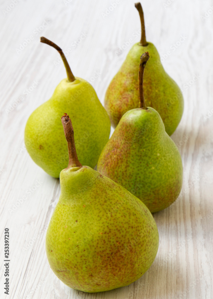 Fresh tasty pears on a white wooden surface, side view. Close-up. Fresh tasty pears on a white wooden surface, side view. Close-up.