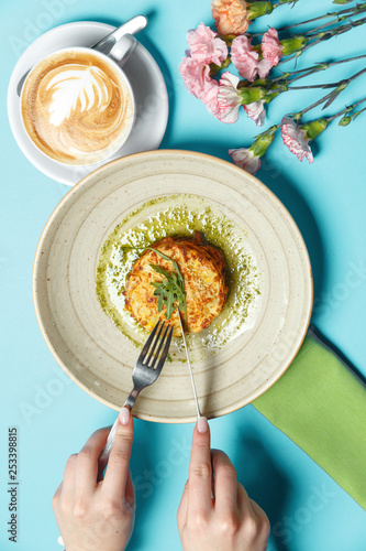 Traditional Italian lasagna. Restaurant table setting on a blue background in a composition with spring cetas and a cup of coffee. Breakfast concept. Top view. photo