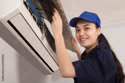 woman technician repair air conditioner photo