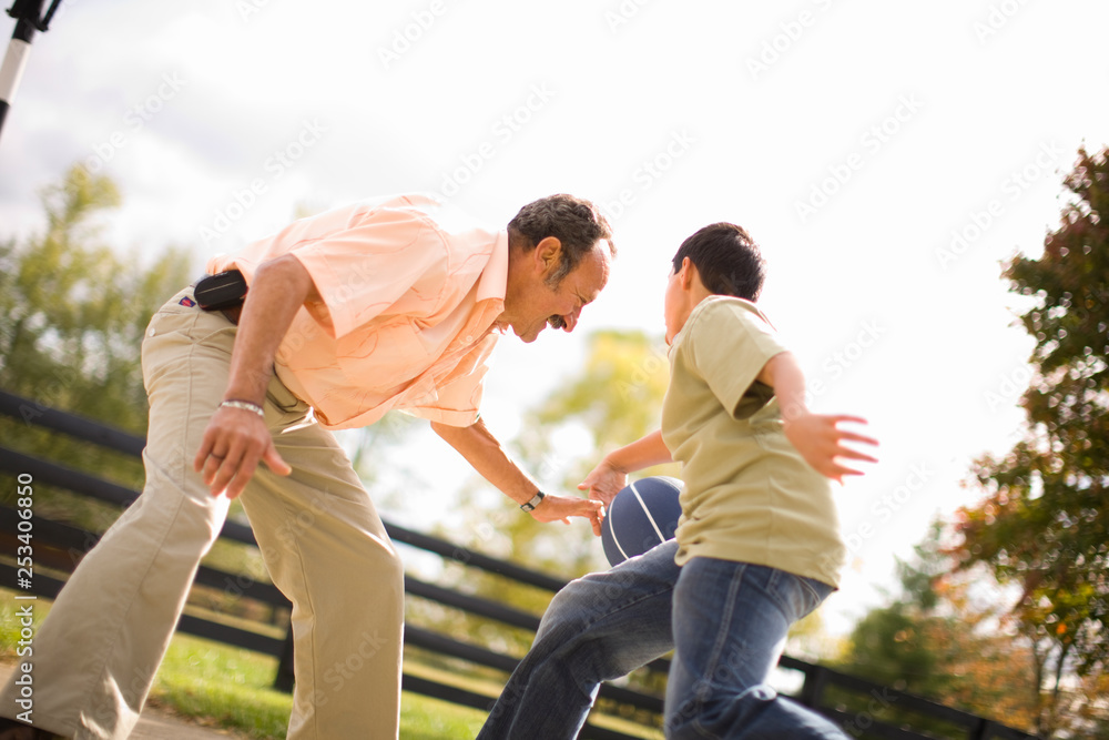 Grandfather and grandson playing basketball