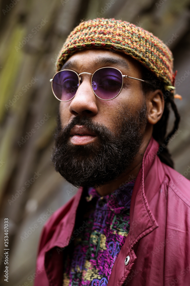 Close up of adult with beard and purple tinted sunglasses Stock Photo
