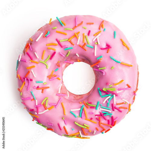 Photo Flat lay pink donut decorated with colorful sprinkles isolated on white background