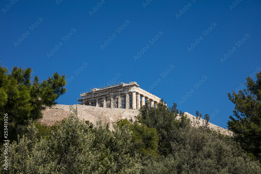 Acropolis of Athens Greece rock and Parthenon on blue sky background, sunny day.