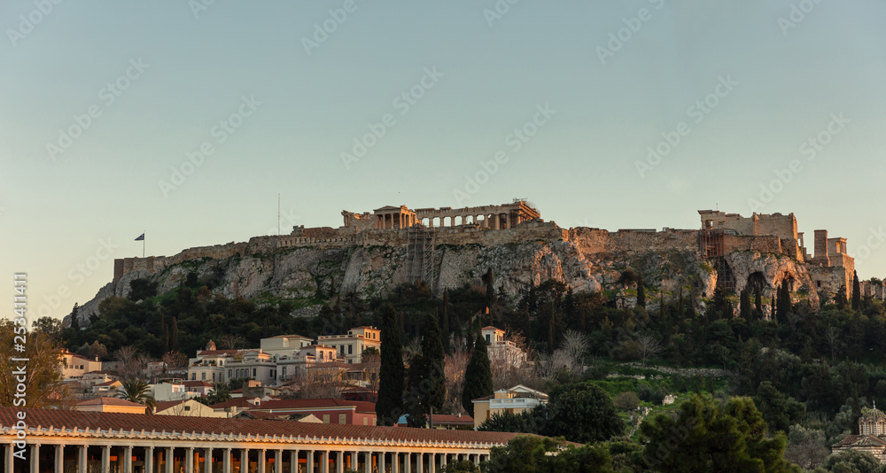 Acropolis of Athens Greece rock and Parthenon on blue sky background in the evening.
