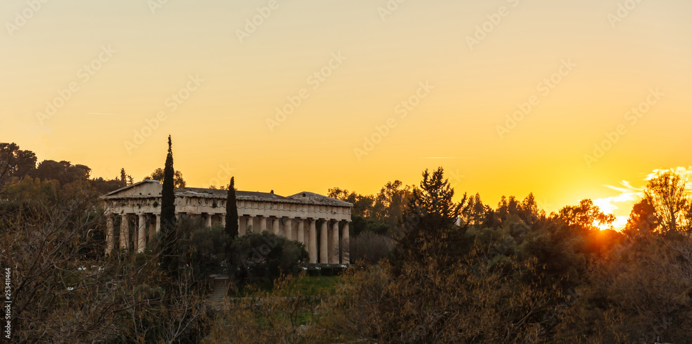 Athens Greece. Hephaestus temple at sunrise time, sun rising against orange color sky