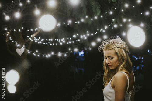 Bride under lights at night