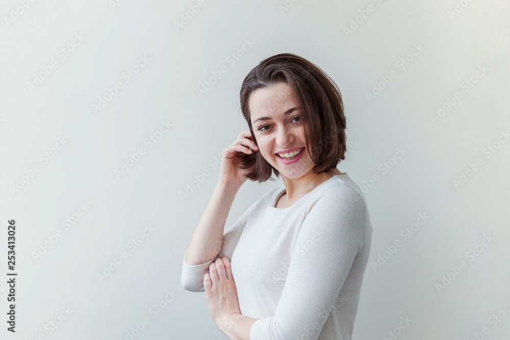 Happy girl smiling. Beauty portrait young happy positive laughing brunette woman on white background isolated. European woman. Positive human emotion facial expression body language Happy girl smiling. Beauty portrait young happy positive laughing brunette woman on white background isolated. European woman. Positive human emotion facial expression body language
