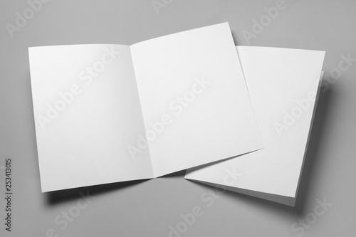 Blank half-folded booklet, postcard, flyer or brochure mockup template on gray background photo