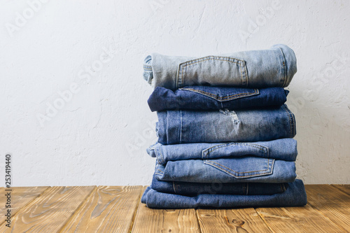 jeans denim cloth garment monochrome blue textile stacked on wooden table