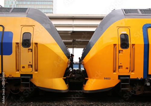 Amsterdam, the Netherlands, March 7, 2019: Two yellow trains or intercities from the NS attached to eachother photo