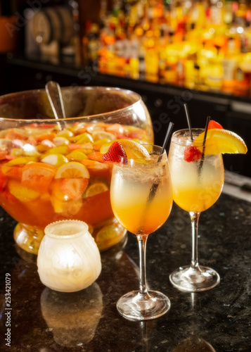 Specialty punch in punch bowl and drinks on bar