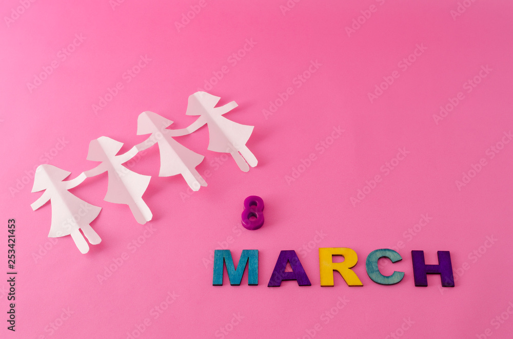 Paper doll chain and march eight made from colorful letters on pink background