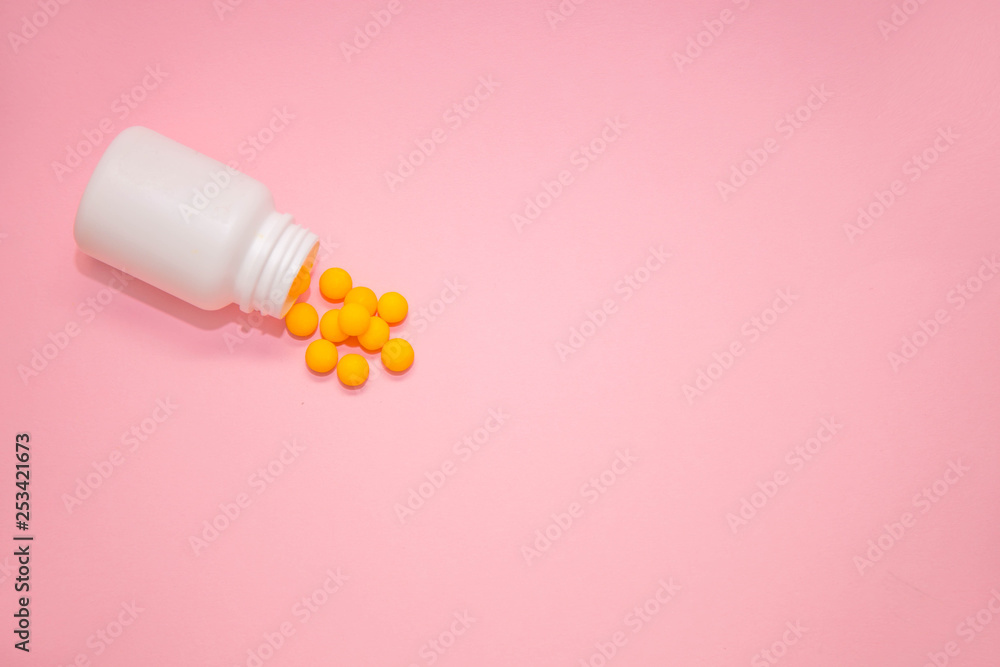 yellow vitamins in a white jar on a pink background. White bank with place for text and tablets. dietary supplements, tablets, vitamins, capsules. The concept of a healthy life. yellow vitamins in a white jar on a pink background. White bank with place for text and tablets. dietary supplements, tablets, vitamins, capsules. The concept of a healthy life.