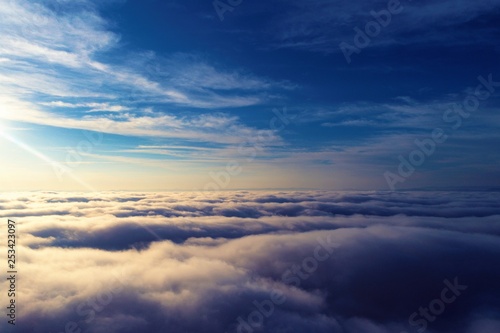 Sun above clouds with a blue sky. Fantastic landscape. Peace, Freedom, overcoming, inspirational, God. Great sky view! Drone flying above clouds. Sunrise view. 