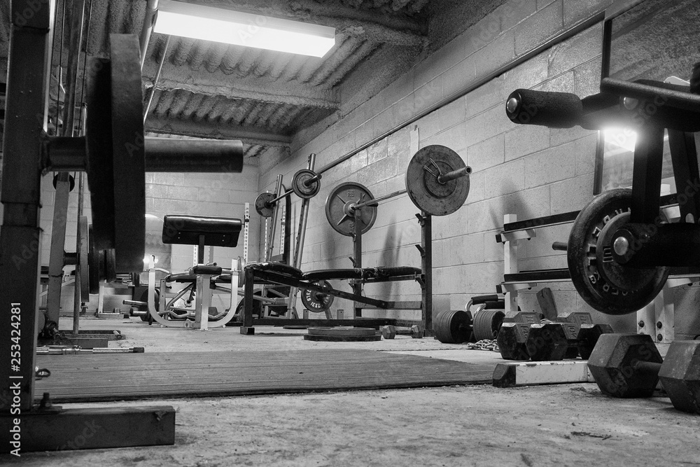 Εκτύπωση καμβά Black and white photo of a dirty, grungy ,hard core, weight room ,gym