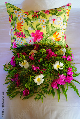 Arrangement of fresh tropical flowers placed on a bed in a luxury hotel in Bora Bora, French Polynesia