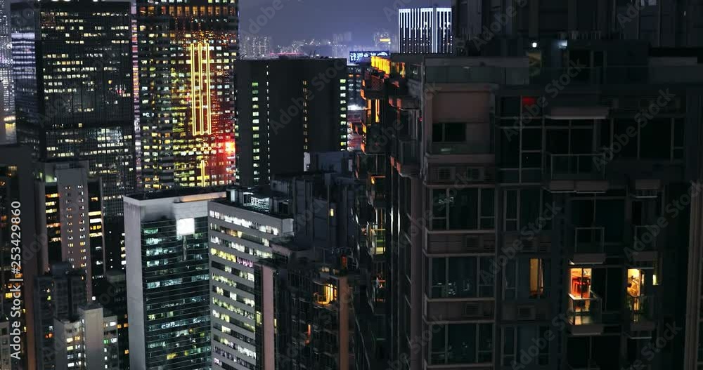 Beautiful night city lights urban background. Dark buildings and tall skyscrapers of Hong Kong downtown Beautiful night city lights urban background. Dark buildings and tall skyscrapers of Hong Kong downtown