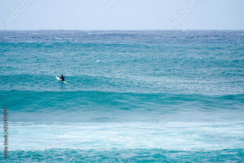 Surfer patiently waiting for the perfect wave