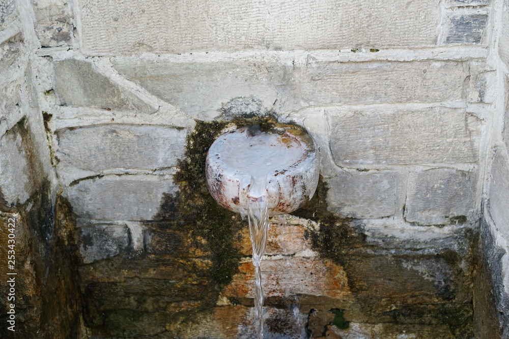 old brick water spigot