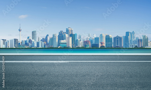 Road with sea and cityscape skyline   morning scene .