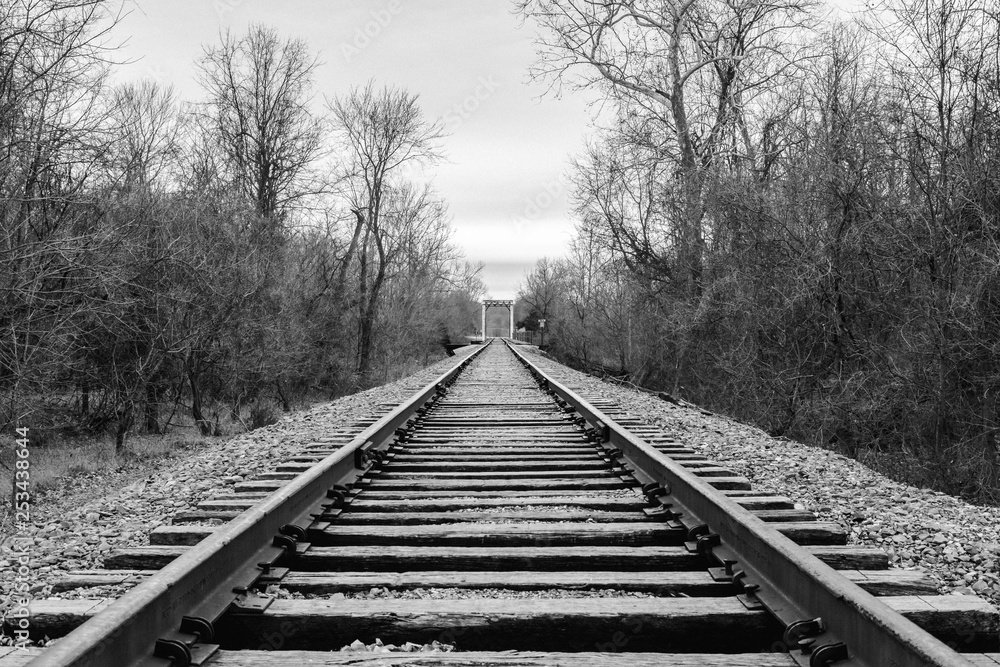 Black and white rail road tracks.