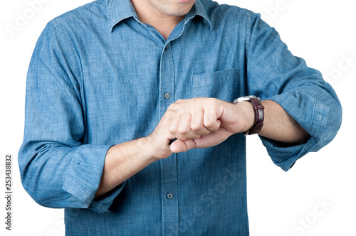 Times concept. Manin blue shirt watch the clock in his hand on isolate background.