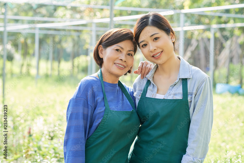Grandmother and granddaughter in their garden