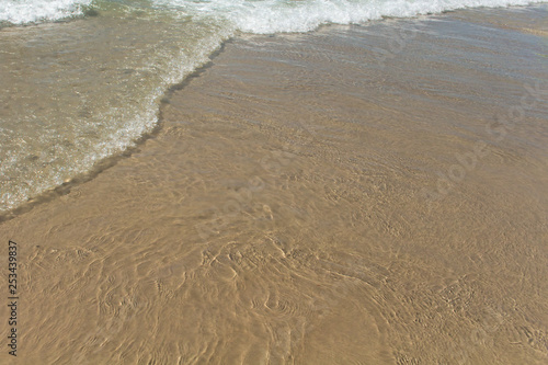 Calm waves on the beach. Backgrounds and Textures