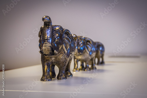 Photography Metal statues of elephants on the flat white surface