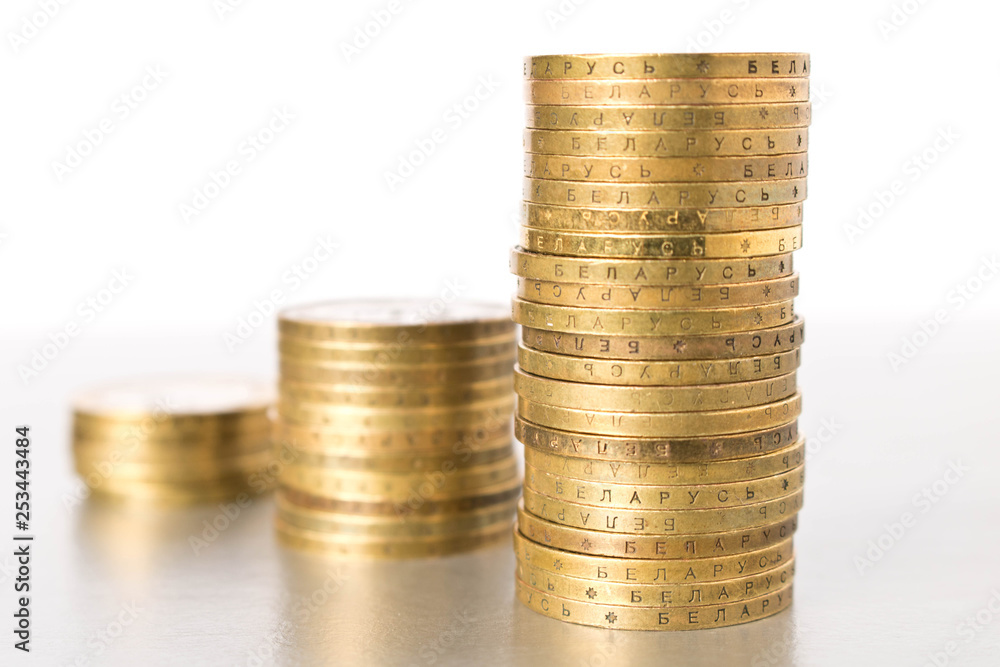 Stacks of coins on a light background. Business concept and growth of capital. Stacks of coins on a light background. Business concept and growth of capital.