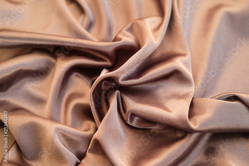 Fabric gold waves - material for background and texture. Close up black fabric.