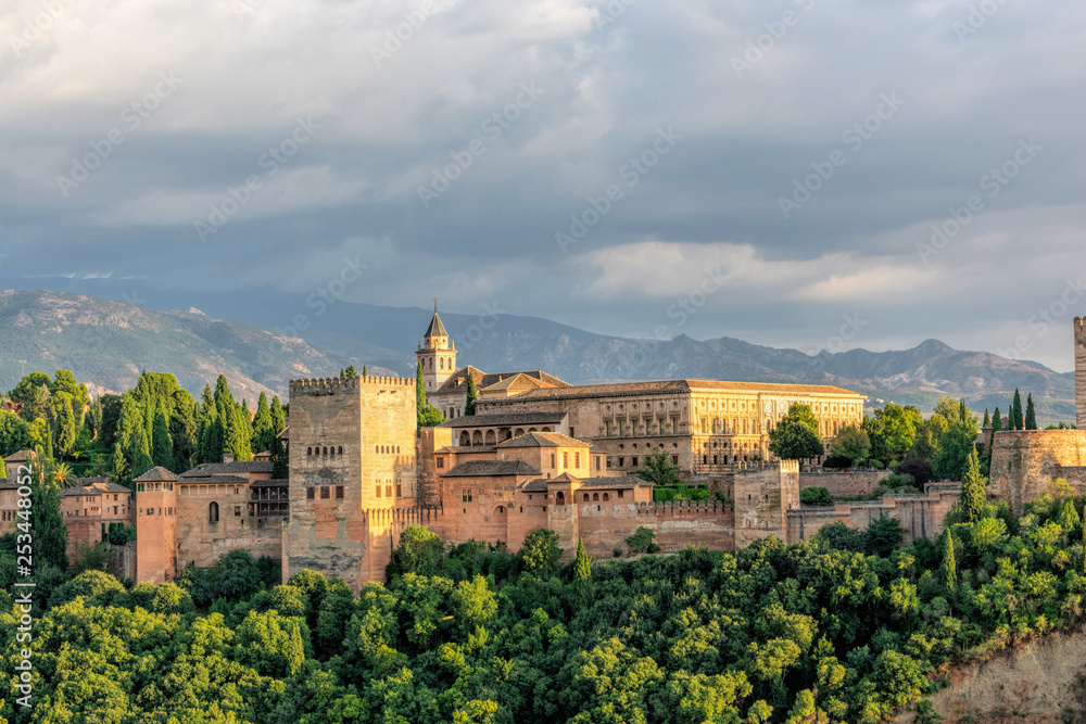 Aerial view of Alhambra Palace in Granada, Andalusia, Spain from Mirador of San Nicolas in Albayzin neighborhood with Sierra Nevada mountains at the background