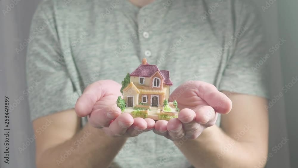 The toy house in hand. concept on the house of your dreams The toy house in hand. concept on the house of your dreams