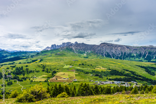 Alpe di Siusi, Seiser Alm with Sassolungo Langkofel Dolomite, lush green field in Seiser Alm Puflatsch Bullaccia