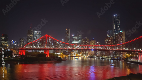 night time shot of the story bridge and ferry in brisbane © chris