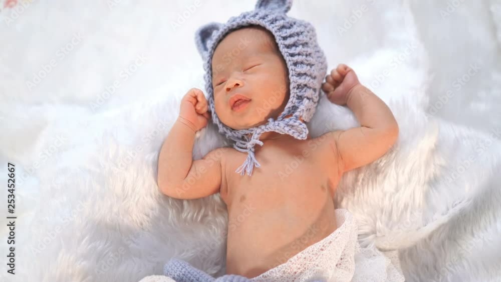 newborn baby in bear hat on a fur bed newborn baby in bear hat on a fur bed