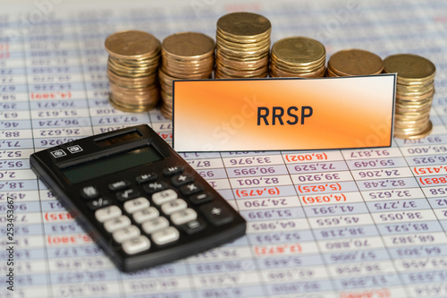 Stacks of coins on spreadsheet showing Growth in RRSP Savings photo